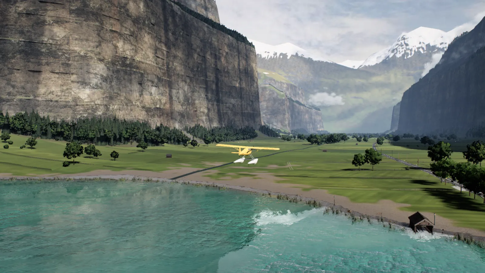The floatplane climbing away from the lake over meadows toward the valley and its snowy peaks
